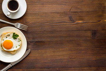 Fototapeta na wymiar Fried eggs on toast on white table top view copy space
