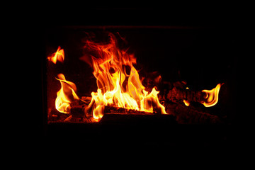 Wood burning in a cozy fireplace at home, keep warm. texture