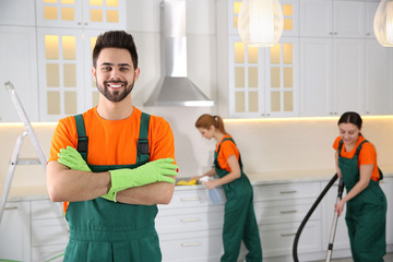 Professional janitor in uniform indoors. Cleaning service