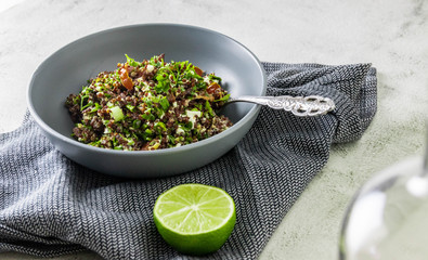 Fresh quinoa with green herbs tomatoes and bacon