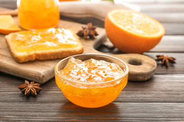 Jar of orange jam on table