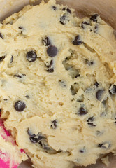 Homemade raw chocolate chips cookie dough on a bowl. Close up view.