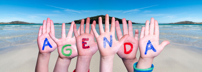 Children Hands Building Colorful Word Agenda. Ocean And Beach As Background