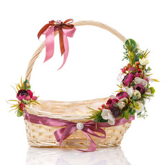 Fototapeta na wymiar Wicker basket with Easter floral compositions on the handle of the basket. Decor with dark pinks and white flowers. Isolated