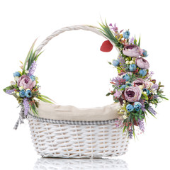Fototapeta na wymiar Wicker basket with floral decor and ribbons on white background on white background