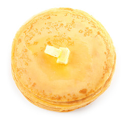 Tasty blini with butter on white background