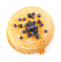 Tasty blini with berries on white background