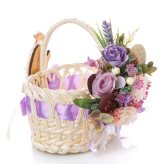 Fototapeta na wymiar Beautiful decorative basket with flowers for Easter celebration on white background
