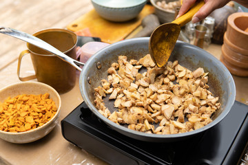 hand cooking turmeric and ginger for jamu herbal drink