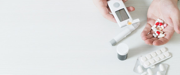 person measures blood sugar with glucometer