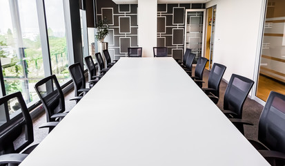 Empty modern boardroom table and chairs