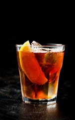 Ice tea with  lemon and ice on a dark