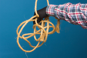 Coarse and worn rope in hand