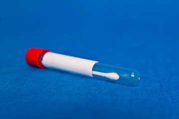 Coronavirus covid-19 nasal swab test vertical on a blue background.
