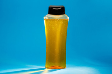 white bottle with cream, shampoo for hair, shower gel, colored background, beautiful studio light, beauty and youth of the human body