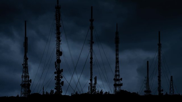 Telecommunication Towers With 4G, 5G and Television Antennas with Lightning and Thunderstorm in Background