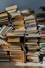 Pile of old books in dramatic dim light