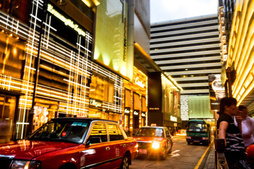 June, 7 / 2013 - Hong Kong: Vibrant city life with red taxi and incidental People at Mongkok district.
