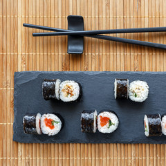 Maki sushi with tuna, salmon and avocado. Nori outside.