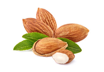Almonds with leaves in closeup isolated on white background.