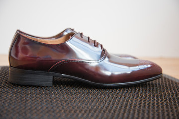 A pair of good beautiful and expensive men's shoes. The concept of success and style. Maroon.