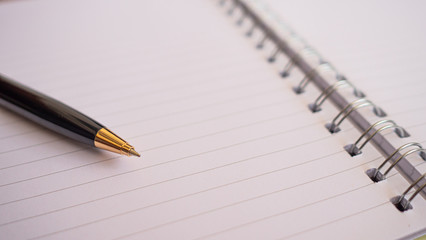 Pen put on notebook  have copy space. 