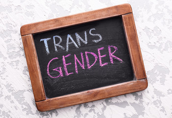 Chalkboard with text TRANS GENDER on light background