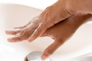 Thoroughly washing hands with soap