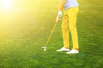 Fototapeta premium Man playing golf in park on sunny day. Space for design