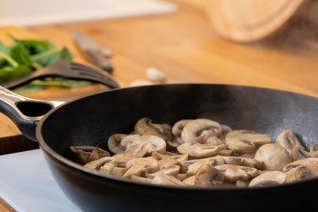 Close-up of mushrooms fried in a frying pan.