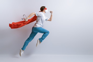 Doctor wearing facemask and superhero cape