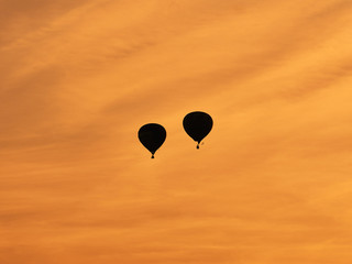 Balloons fly over the city. Warm summer evening. Balloon Festival