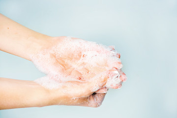 
Hands in soap on a blue background