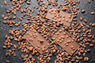 Sweet chocolate with nuts on dark background