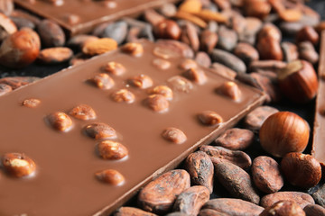 Sweet chocolate with nuts on table, closeup