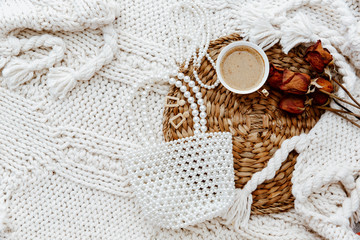 Fashion, beauty, lifestyle blogger  workspace. Coffee cup,  female accessories over wool blanket. Flat lay, top view lifestyle, still life concept