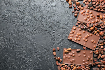 Sweet chocolate with nuts on dark background