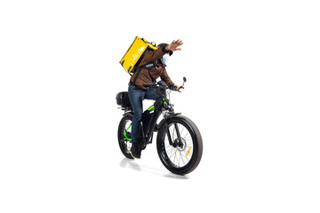 Too much orders. Contacless delivery service during quarantine. Man delivers food during isolation, wearing helmet and face mask. Taking food on bike isolated on white background. Safety. Hurrying up.