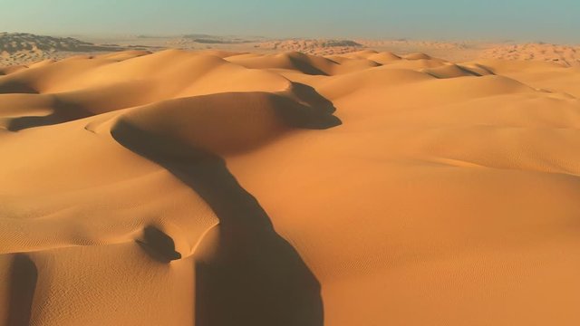 Rub' al Khali (Empty Quarter), Arabian Peninsula. Flying over sand dunes in desert. Camera moving rightwards. Aerial shot, UHD