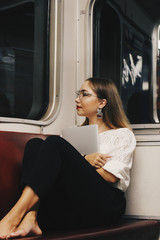 young woman sitting on a train