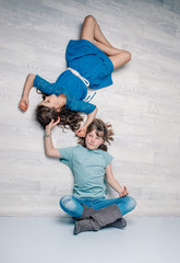 studio photo of two sistes, children, girls having fun