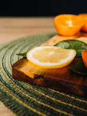 Lemon slice with orange in the background