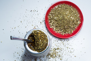 Traditional South American Yerba Mate tea and dry yerba mate, top view on white 1