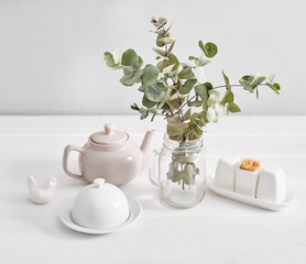 Tableware and decorations for serving festive table on light background.