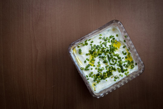 Plain Curd Or Yogurt Or Dahi In Transparent Glass Bowl - 
Top View - Wood Background