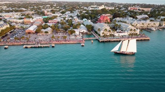 Beautiful 4K aerial drone shot panning up to Mallory Square in Key West, Florida during sunset