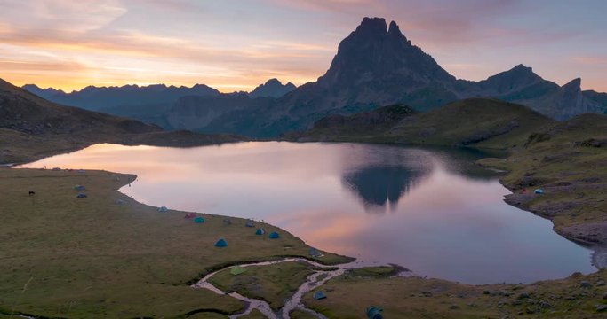 Time lapse of Beautiful sunrise in Lac Gentau, french pyrenees. Colorful sky and mountain lake reflection.