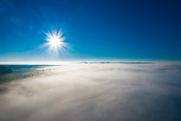 Fototapeta na wymiar Wonderful foggy morning in the Ukrainian village on the Carpathian Mountains with sunshine
