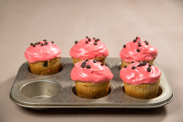 muffins with red cream and chocolate chips