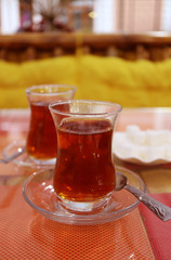 Two Glasses of Hot Turkish Tea and a Plate of Sugar Cubes with Selective Focus